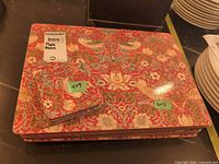 Stack of placemats with one coaster on top showing matching design and size labels