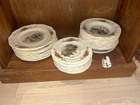 Three stacks of Obernai pattern plates on shelf