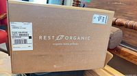Front of sealed Rest Organic box showing branding and shipping label
