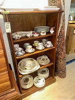 Full view of front of wood shelving unit with four shelves