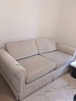 Front view of fabric sofa bed showing overall style and cushions