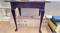 Full view of wooden console table front and legs