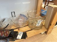 Overall view: two glass punch bowls, eight cups inside larger bowl, ladles, glass ice bucket