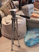 Full view of Velbon VEB-3 tripod standing extended with phone mount attached