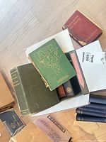 Box of assorted hardcover books with Aesop’s Fables on top and other titles visible