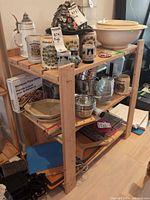 Full view of wood shelving showing three shelves and contents (contents excluded)