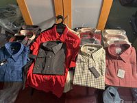 All sixteen shirts displayed folded or on hanger showing tags and packaging