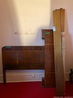 Headboard, footboard, rails leaning against wall