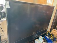 Front view of JVC 70-inch television on integrated stand