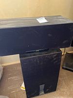 Front view of stacked JVC center speaker on top of powered subwoofer