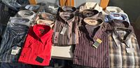 All 18 shirts arranged on table showing variety and packaging