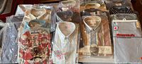 Overview of packaged shirts laid out, showing multiple brands and styles