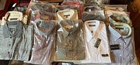 Overview of multiple packaged dress shirts and polos laid out