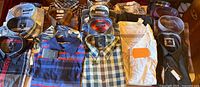 Group shot of all 20 folded shirts showing variety of colors and patterns