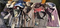 All 20 new men’s shirts folded on surface