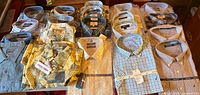 Overview of 20 folded men’s shirts, most in packaging