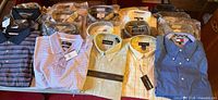 Overview of 20 shirts, several packaged, assorted colours and brands