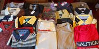 All 21 shirts laid out showing variety of colours, styles and some packaging