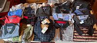 All 21 polo shirts laid out showing variety of colours and patterns