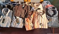 Full lot showing all 21 folded shirts on table