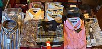 All 21 shirts laid out showing variety of colours, patterns and tags