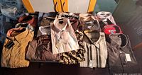 Overall view of 21 folded shirts with tags
