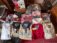 Overview of stacked packaged shirts showing quantity and variety