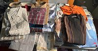 Group view of stacked shirts showing variety and quantity