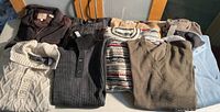 Group shot of all nine sweaters laid out on table
