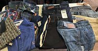 Overview of shirts and jeans laid on table