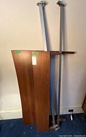wood headboard and footboard leaning against wall with two steel side rails
