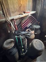 group showing milk cans, ropes, tractor grille, funnel, cord, green jack