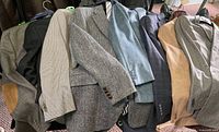 Row of assorted blazers and jackets laid over rack