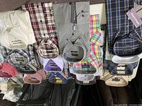 Row of folded shirts showing various brands and patterns