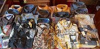 Overview of entire assortment of button-up shirts laid out in two rows