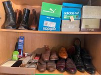 Overview of shelves with boots, shoe boxes, multiple shoe pairs, care accessories