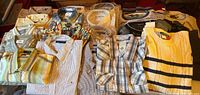 Overview of all folded shirts and sweaters on table