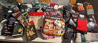 Mixed lot showing all packaged socks, underwear and thermals on table