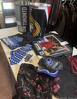 Entire lot overview showing waste bins, apparel, framed photo, and keychains