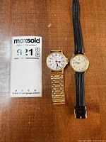 Both wristwatches side-by-side with MaxSold card