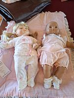 Both Bitty Baby dolls on pink quilted pad