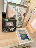 All three framed art pieces on countertop