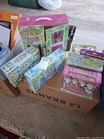 Stacked sealed Calico Critters Carry & Play Case, Bathroom Set, Wedding Luncheon Set, Lambrook Sheep Family boxes