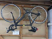 Full view of Cannondale Synapse bicycle hanging upside down, showing frame, wheels, drivetrain, saddle bag