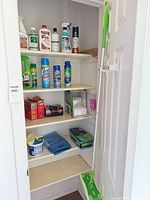 Full closet view showing grouped cleaning products and Swiffer mop