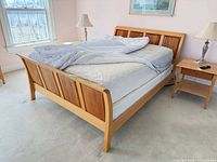 Full view of assembled Copeland queen bed frame with mattress