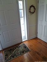 Door mat placed on hardwood floor in entryway