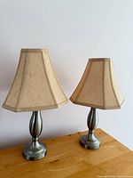 Pair of matching table lamps on wooden surface showing overall appearance