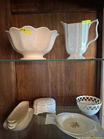 Top shelf with Lenox scalloped bowl and embossed pitcher