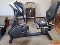 Full side view of BH recumbent exercise bike showing console, seat, pedals, and frame